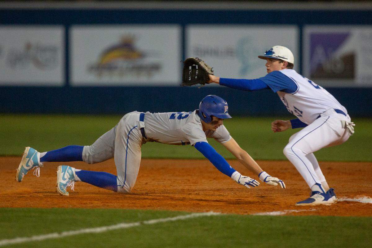Jackson Prep’s Konnor Griffin slides back to first base before Ocean Springs’ Adam Clower can tag him out during a game in Ocean Springs on Monday, March 11, 2024.