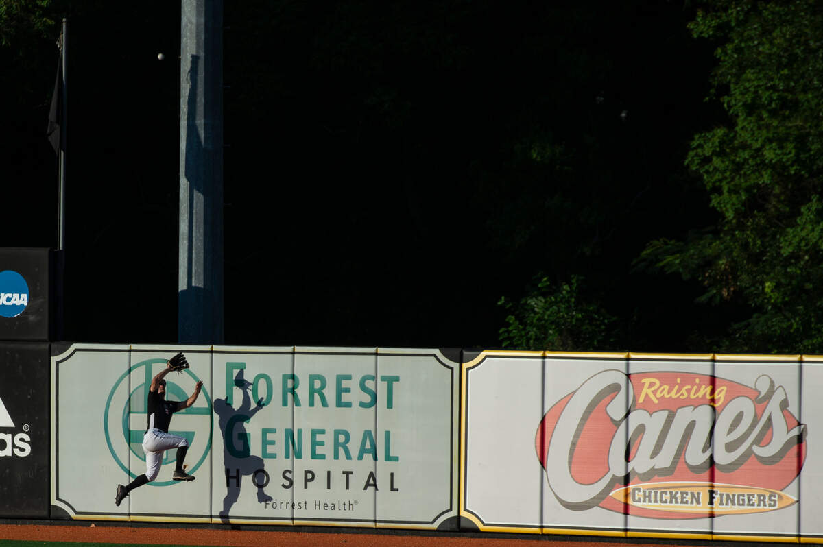 A Southern Miss outfielder tries to make a catch as the ball goes out of bounds during Game Four of NCAA Regionals at Pete Taylor Park in Hattiesburg on Saturday, June 4, 2022.