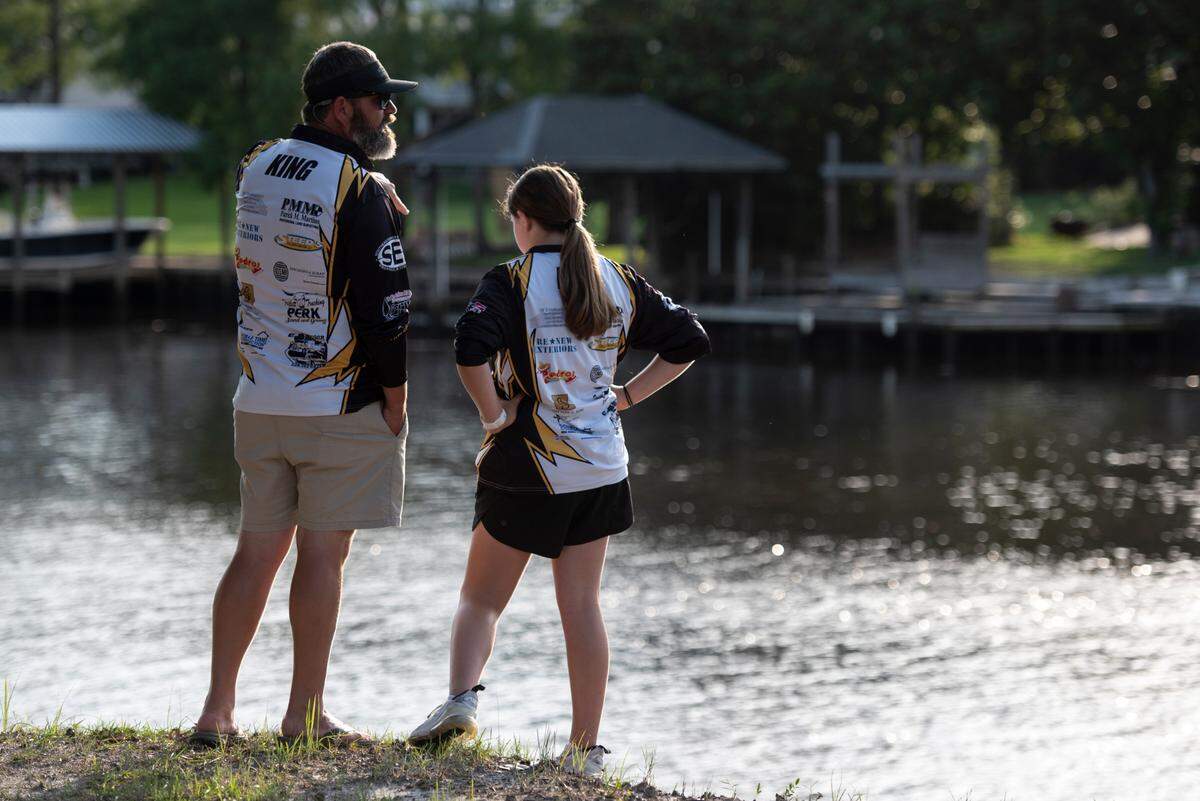 D’Iberville Bass Fishing Team member Olivia King, right, and her dad and coach Hiram King talk before fishing on the Tchoutacabouffa River in D’Iberville on Monday, June 3, 2024.