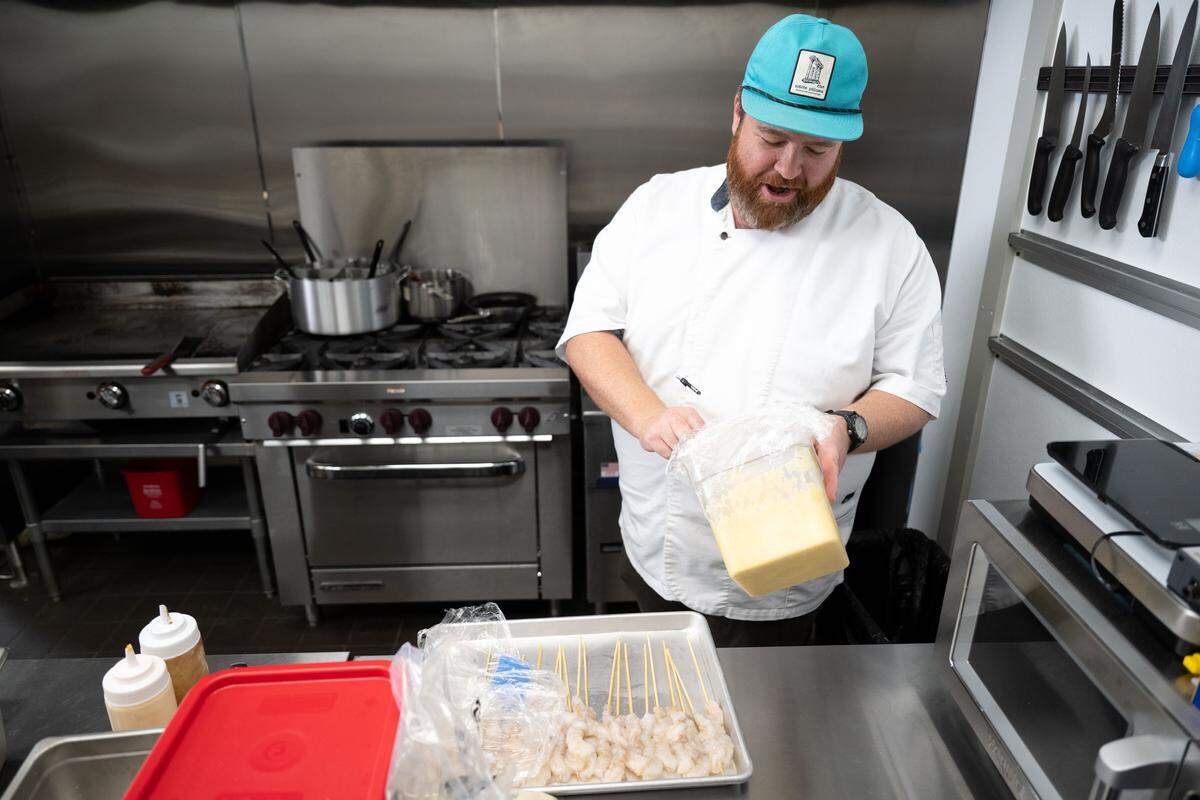 Chef Austin Sumrall prepares his signature shrimp corndogs at Chandeleur Depot Brewpub in Pascagoula on Wednesday, May 20, 2026.