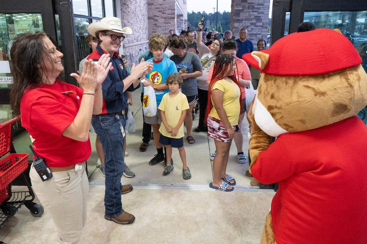 Randy Pauly, Buc-ee’s pitmaster, and Buc-ee the beaver welcome customers to the opening of the Harrison County Buc-ee’s on Monday, June 9, 2025.