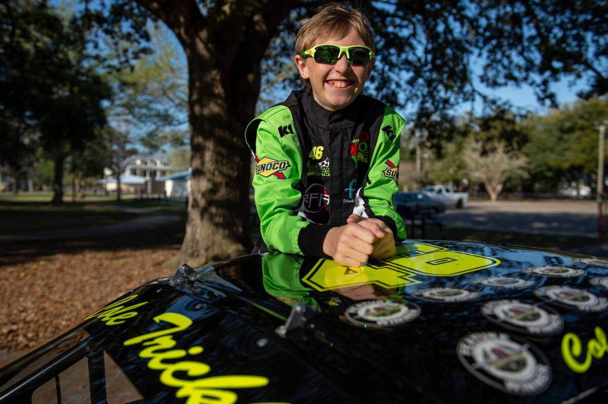 Nicolas “Cole” Denton, 11, also known as “Cole Trickle”, after the iconic Days of Thunder movie character, poses next to his Bandolero racecar at Pascagoula Beach Park in Pascagoula on Thursday, March 10, 2022.