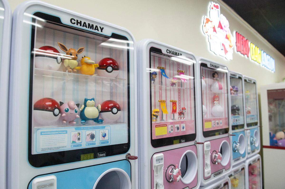 Games at Hero Claw Kingdom with neon and music is a part of Emmay Mochi Donuts, Desserts & More in D’Iberville