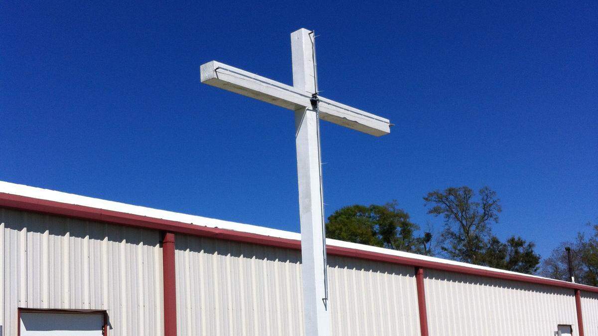 TAMMY SMITH/SUN HERALDThis cross at Edgewater Christian Fellowship in Biloxi has been illuminated with LED lighting and is telling the story of the Crucifixion through lights during the Easter season.