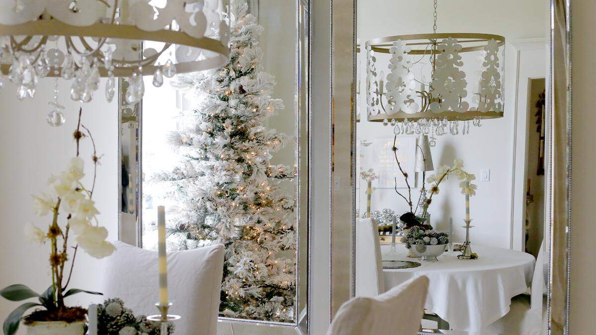 AMANDA McCOY/SUN HERALDA white Christmas tree matches the light decor of Jaye Raines' dining area on Tuesday, December 1, 2015. Raines' home will be one of four featured this year in the Gulfport Civic League's Holiday Tour of Homes.