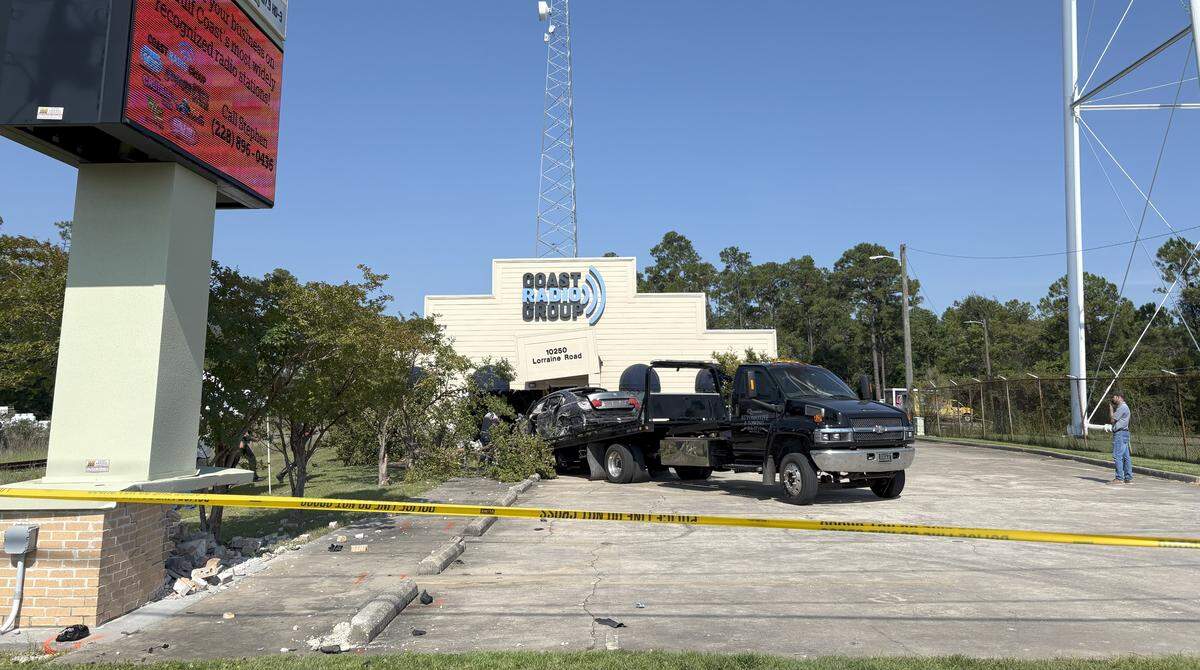 A car is pulled out of the Coast Radio Group building after a crash Friday, August 1, 2025, in Gulfport.