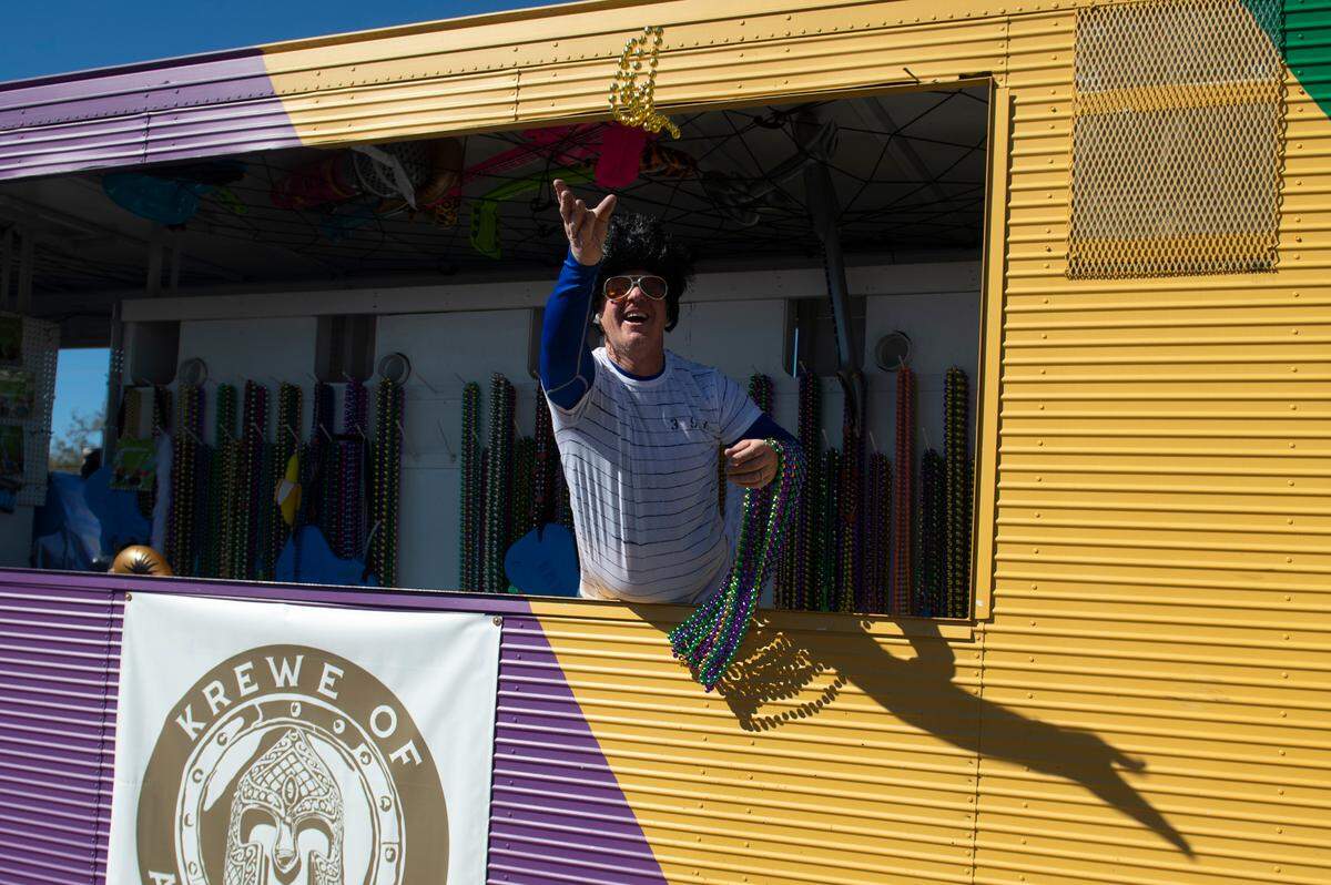 A float rider dressed as Elvis tosses beads during the Krewe of Nereids Mardi Gras parade on Highway 90 in Bay St. Louis on Sunday, Feb. 12, 2023.