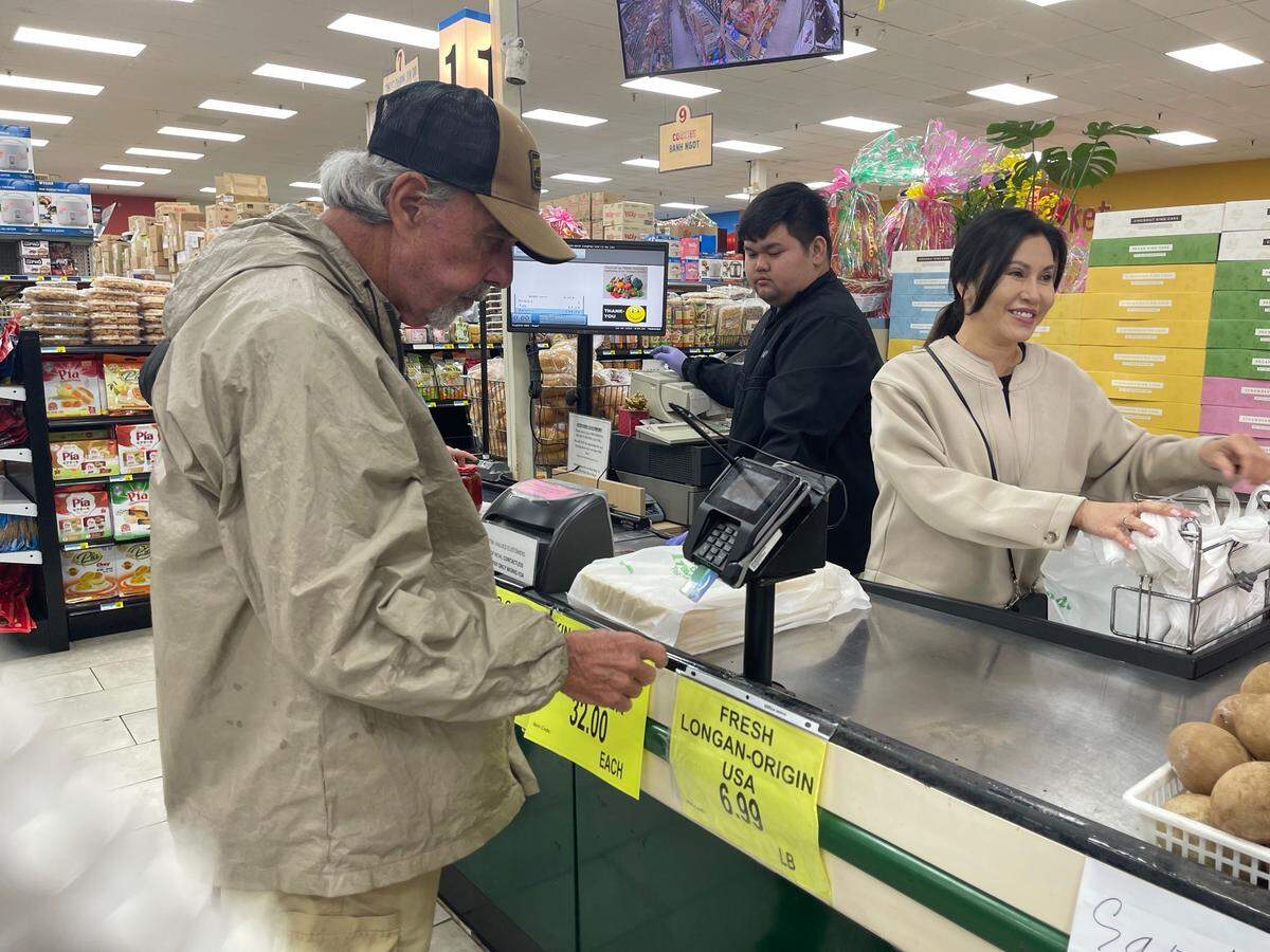 Vivian Nguyen, right, said Lee’s International Market in Biloxi, where she works, tried for years to get on the list for Dong Phuong Bakery king cakes. This year, Lee’s is finally able to offer the prized treats, but only on Fridays. She’s hoping a second day of the week can be added. Cashier Aiden Vo rang up customer Mike Appe’s king cake.