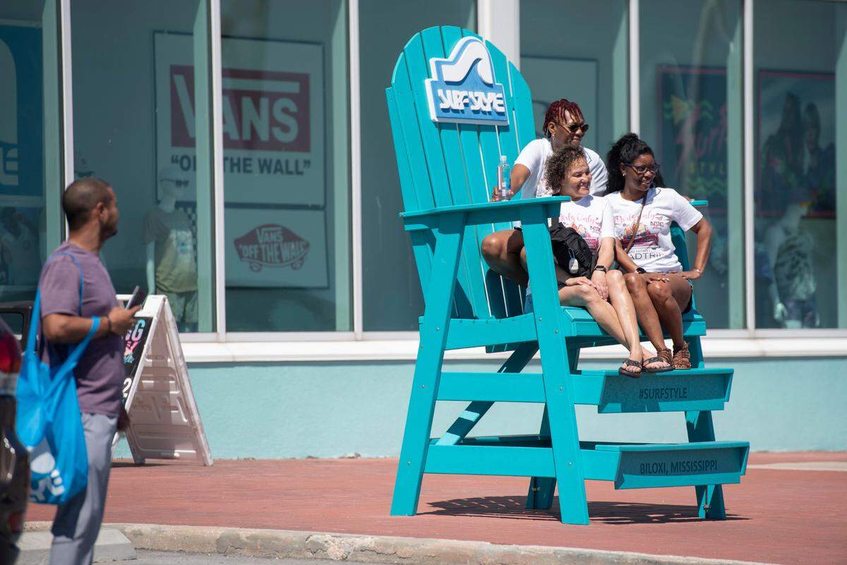 Visitors take photos at Surf Style during Black Spring Break on Saturday, April 12, 2025.