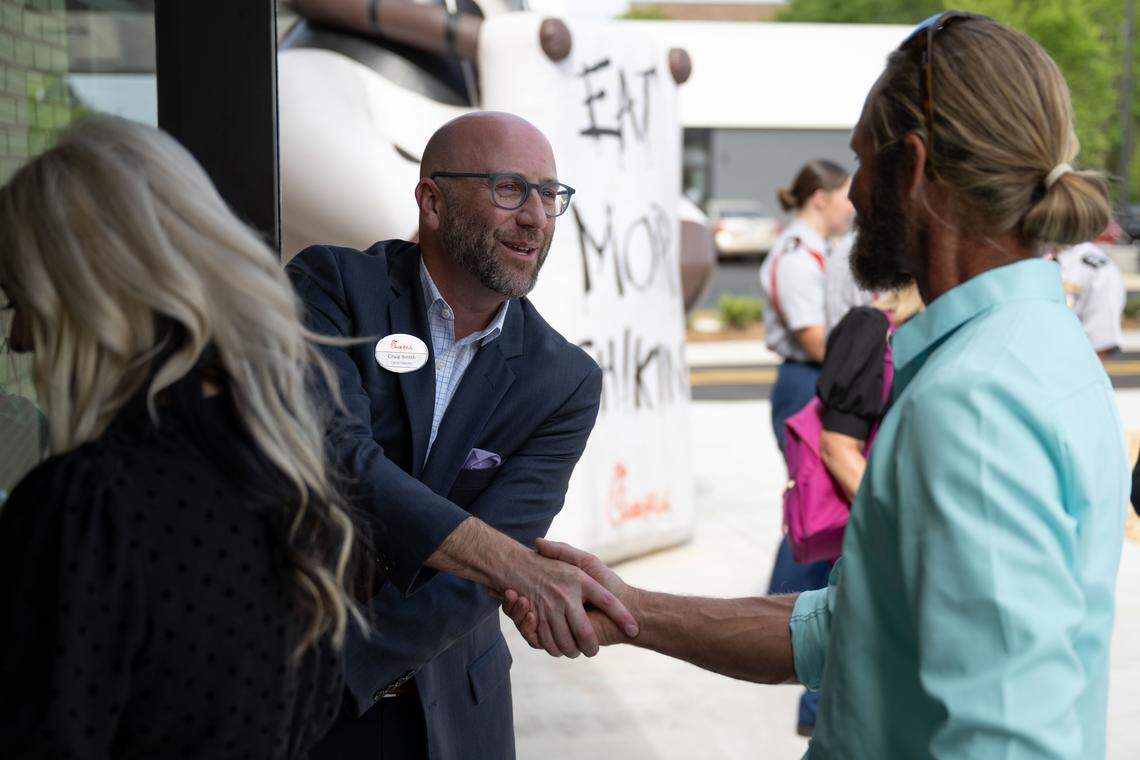 Owner-operator Craig Smith welcomes people into the new Chick-Fil-A in Ocean Springs following a ribbon-cutting ceremony Wednesday.