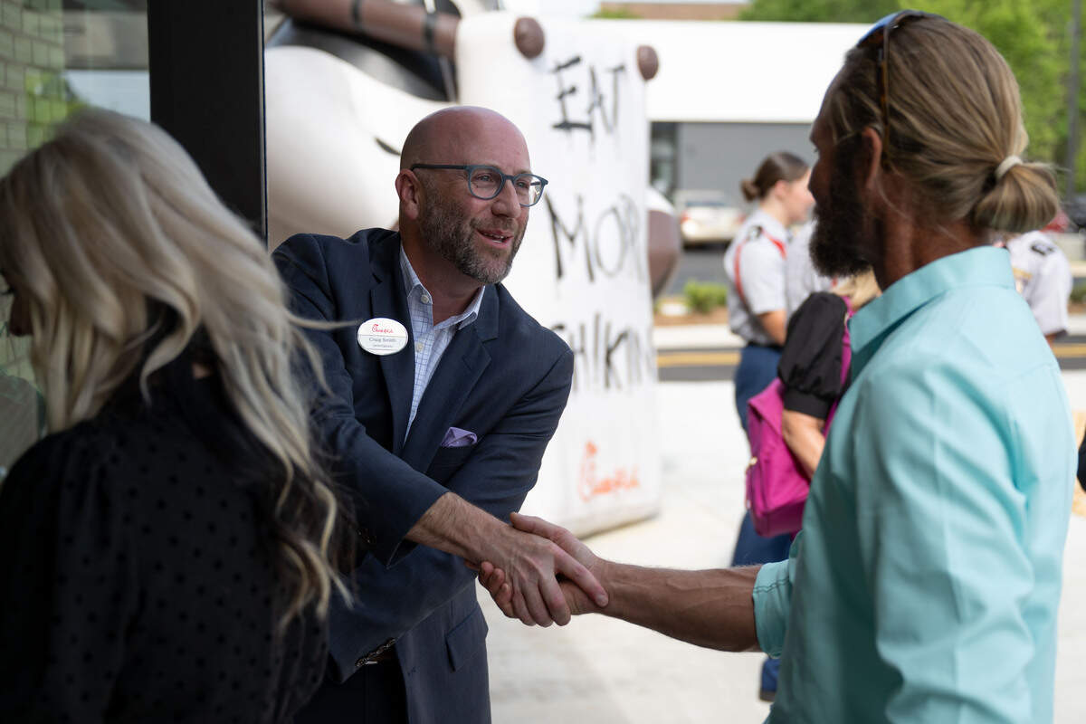 Owner-operator Craig Smith welcomes people into the new Chick-fil-A in Ocean Springs following a ribbon-cutting ceremony Wednesday.