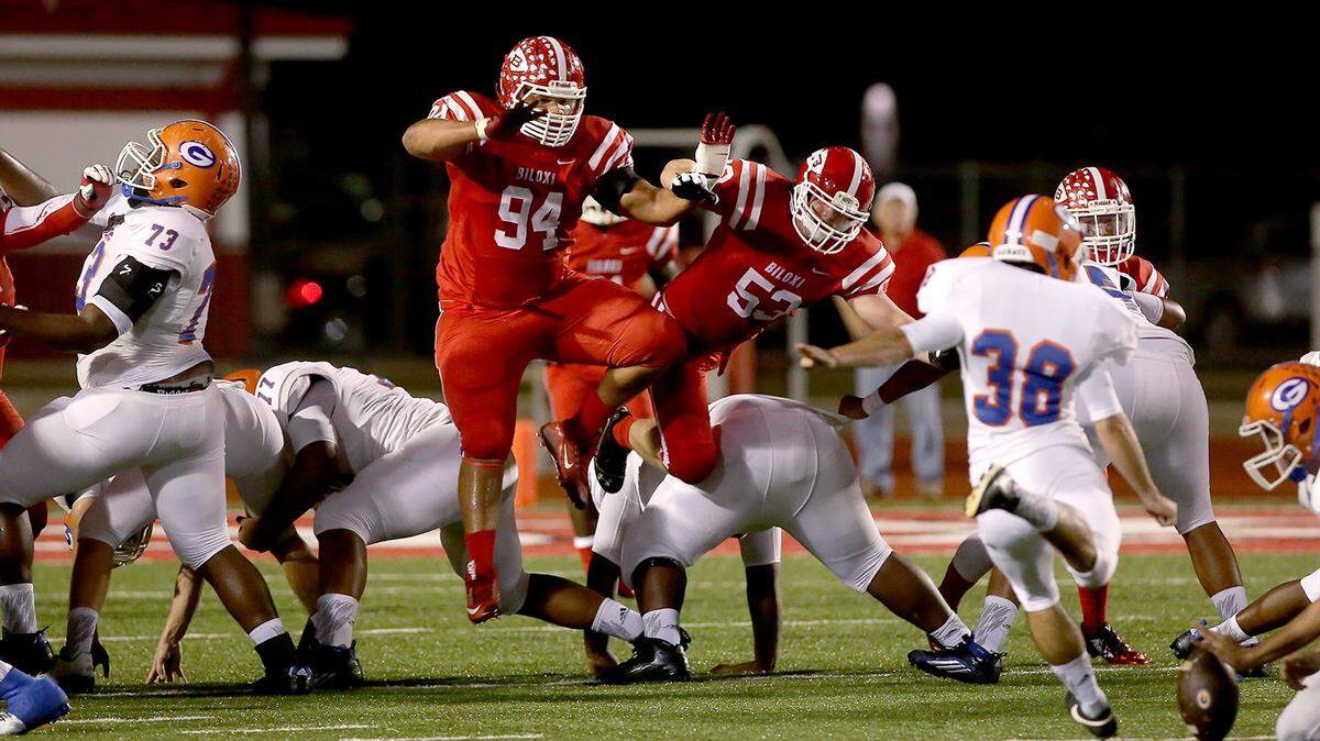 AMANDA McCOY/SUN HERALD 
 Biloxi's Blayr Case and Matthew Lawrence break through Gulfport's extra-point protection during the rivalry game. The Indians finished the season 3-8.