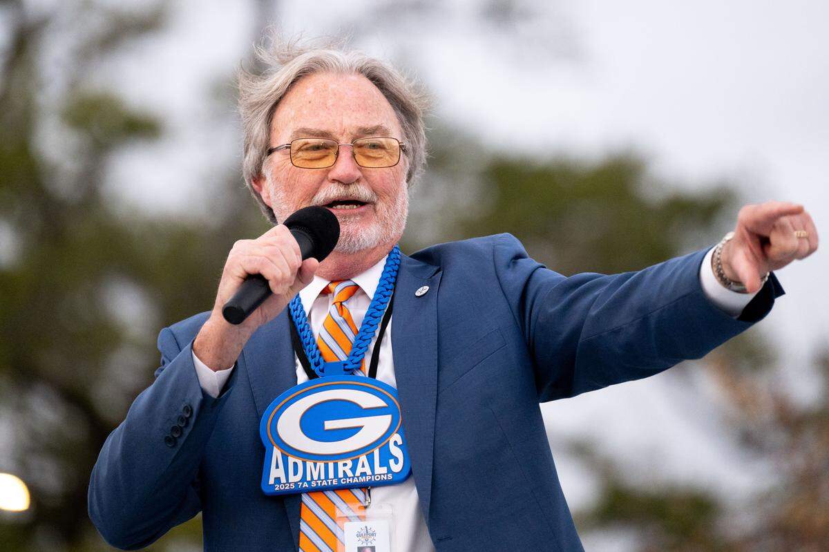 Gulfport Mayor Hugh Keating congratulates the Gulfport football team during the Champions Christmas Parade in Gulfport on Monday, Dec. 8, 2025.