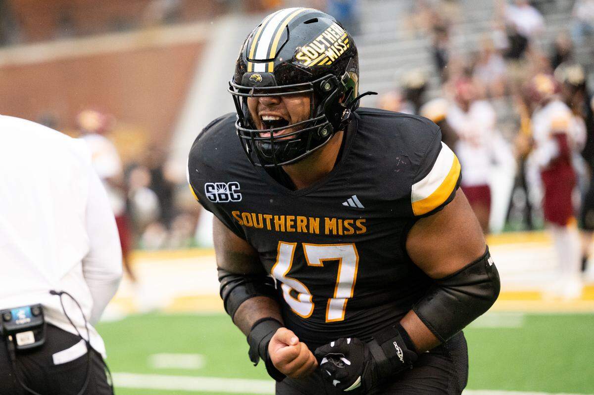 Southern Mississippi offensive lineman Broderick Roman (67) celebrates a touchdown during the Golden Eagles’ victory Saturday.