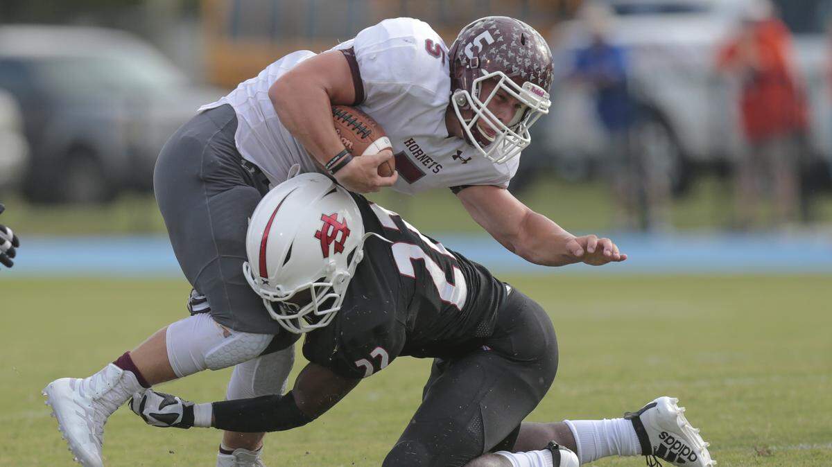 East Central quarterback Will Young (5) is tackled by Harrison Central outside linebacker Raymond Collins (22) during the Port City Classic game between East Central and Harrison Central at Milner Stadium, Gulfport on Friday, August 23, 2019.