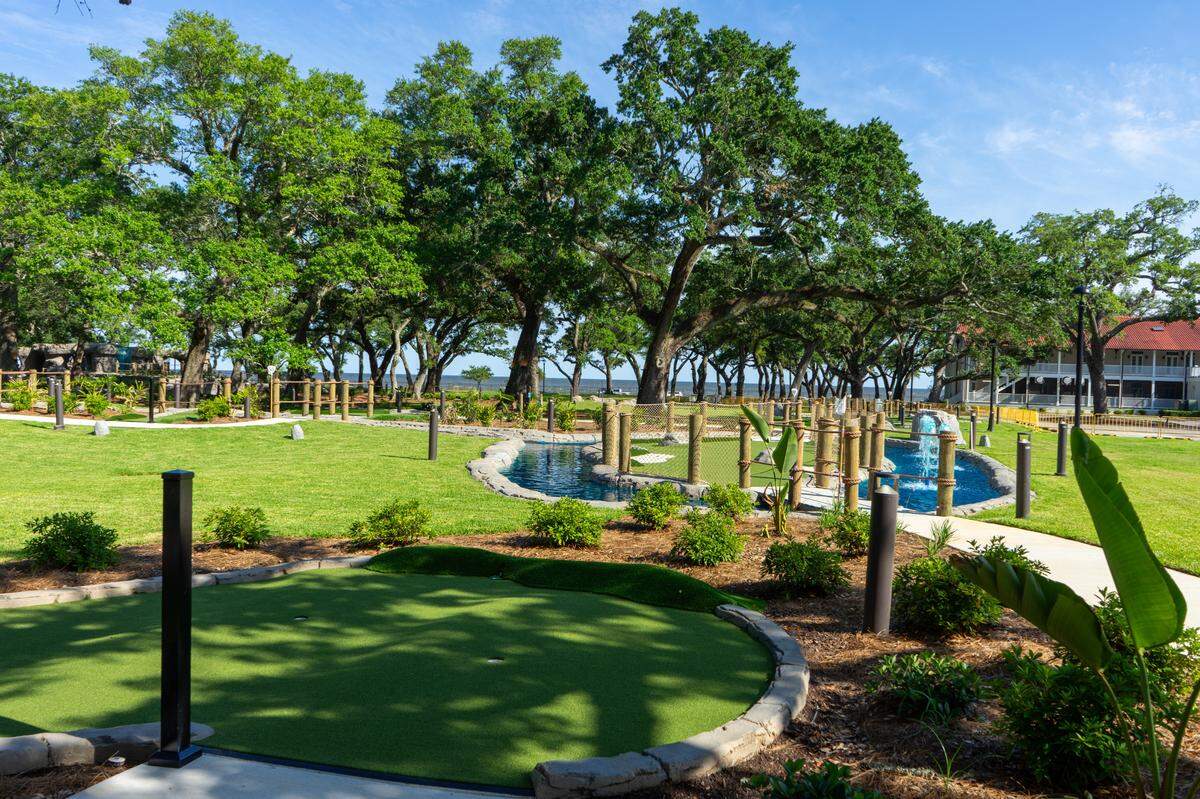 Two 18-hole putting golf courses were carefully built under the shady oak trees at Centennial Plaza Resort in Gulfport and will open this summer at part of Hippie Fish entertainment center.