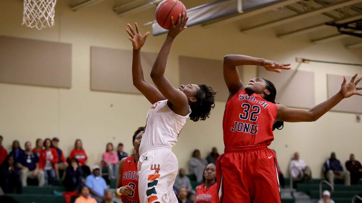 AMANDA McCOY/SUN HERALD 
 West Harrison's Ameysha Williams takes a shot while defended by South Jones' Endia Holliday during Class 5A second-round state basketball playoffs on Friday, Feb. 27, 2016, at West Harrison High.