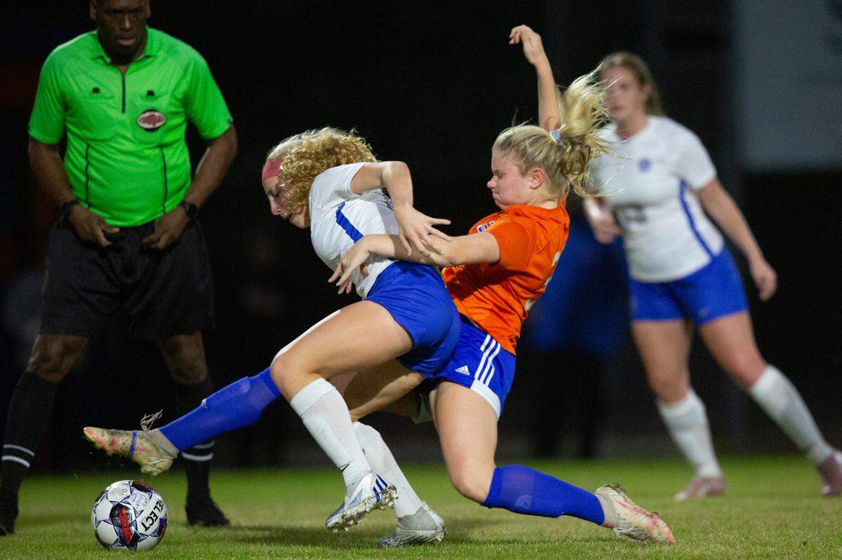 Gulfport’s Alexandria Gant slide tackles Ocean Springs’ Parker St. Amant during the 6A South State Championship game in Gulfport on Tuesday, Jan. 31, 2023.