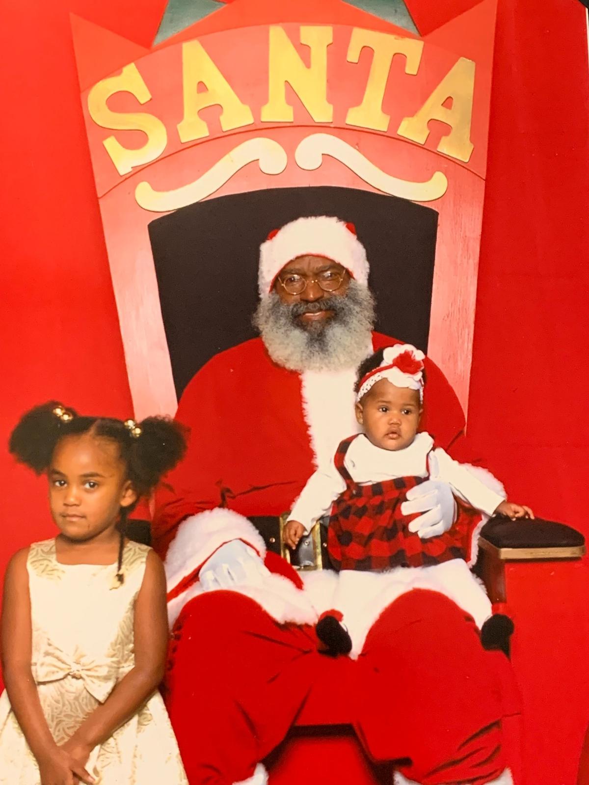 Derek Hillard’s then-six-month old daughter, Zylah, sits on Santa’s lap in 2019, with his niece. Samuel Smith was portraying Santa for the first time.