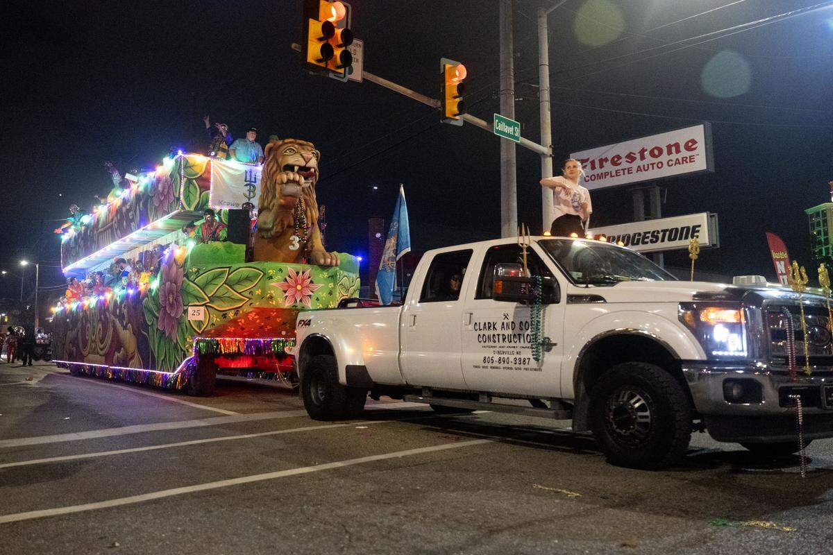 A parade float with a lions statue passes through Howard Avenue during the Krewe of Neptune parade in Biloxi on Saturday, Feb. 14, 2026.