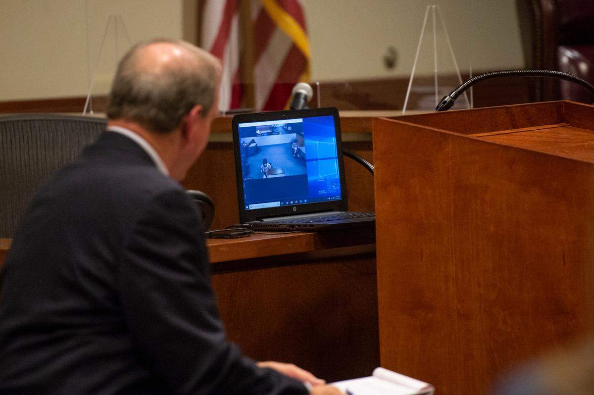 Prosecutor Herman Cox questions defendants Vincent Jaquan Armstrong and Khalid Williams over a video call during an initial court hearing at Harrison County Justice Court on Wednesday, Jan. 19, 2022. Armstrong and Williams are among four charged with murder following a shooting that killed four at a residence in Gaston Point on New Years’ Eve.