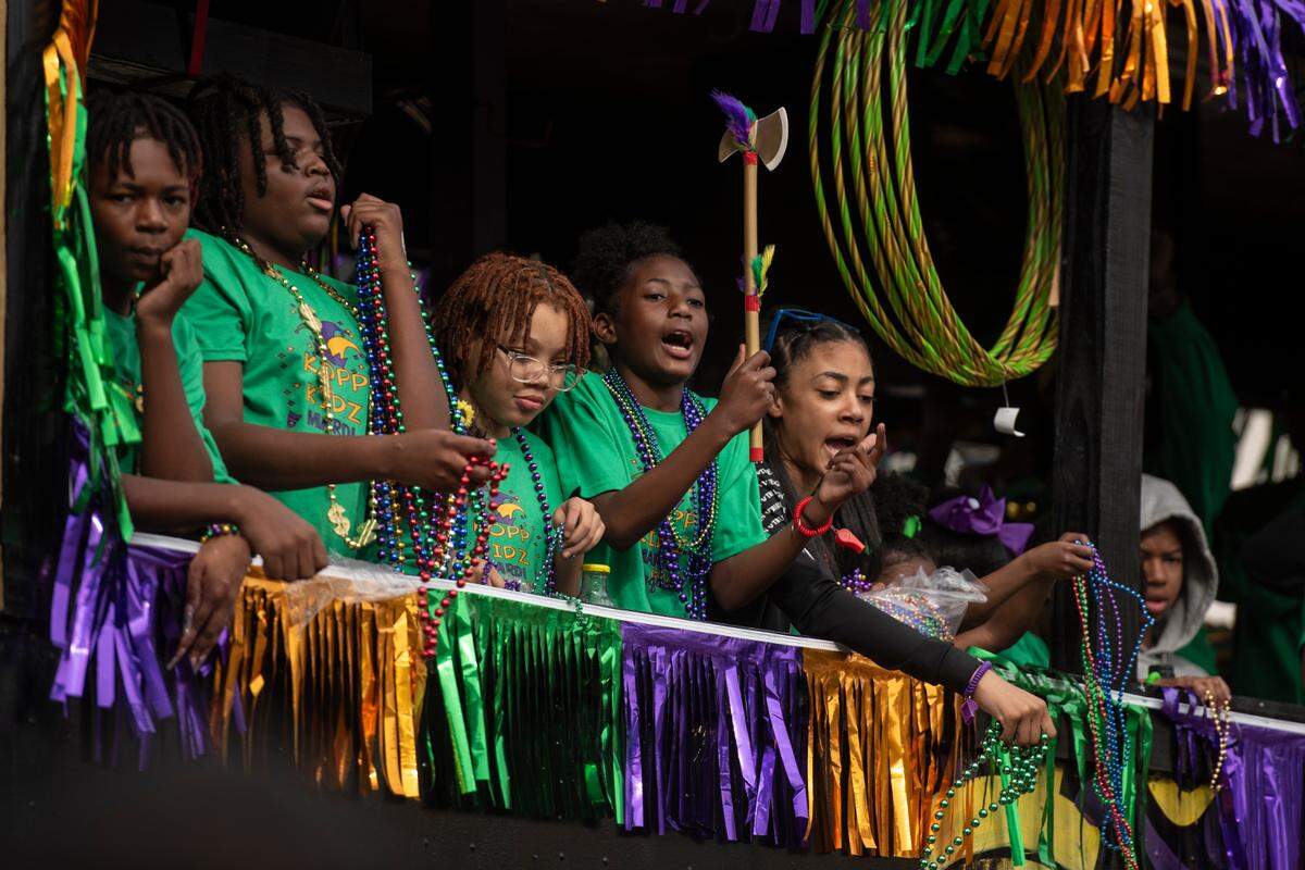 Float riders throw beads from a float during the Krewe of Gemini parade in downtown Gulfport on Saturday, Feb. 10, 2024.