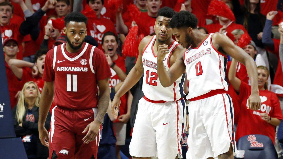 Ole Miss forward Bruce Stevens (12) confers with guard Blake Hinson (0) as he kisses his biceps after scoring on a dunk while Arkansas guard Keyshawn Embery-Simpson (11) walks away during the second half of the NCAA college basketball game in Oxford on Jan. 19, 2019.
