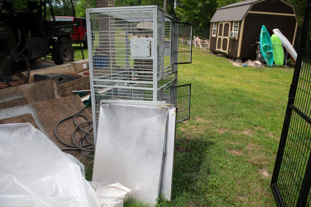 A metal cage that originally housed Diego and Balou when April Stewart rescued them sits in a workshop area at Gulf Coast Primate Sanctuary in Perkinston on Thursday, May 1, 2025.