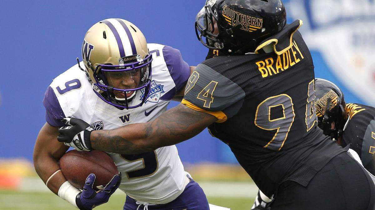 Washington fullback Myles Gaskin (9) runs against Southern Mississippi defensive lineman Dylan Bradley (94) during the first half of the Heart of Dallas Bowl NCAA college football game Saturday, Dec. 26, 2015, in Dallas. (AP Photo/Ron Jenkins)