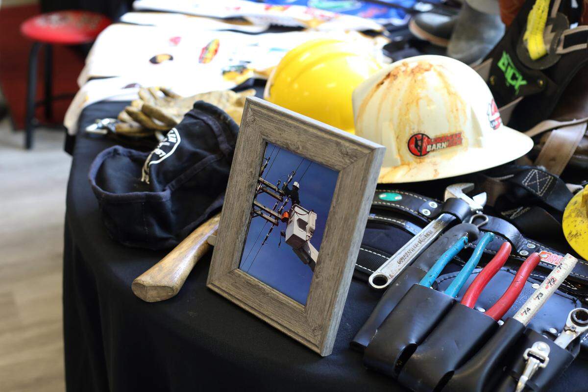 Guests viewed a table filled with lineman’s gear at the funeral service for Cayce Seal at St. Clare Catholic Church in Waveland on July 1, 2021.