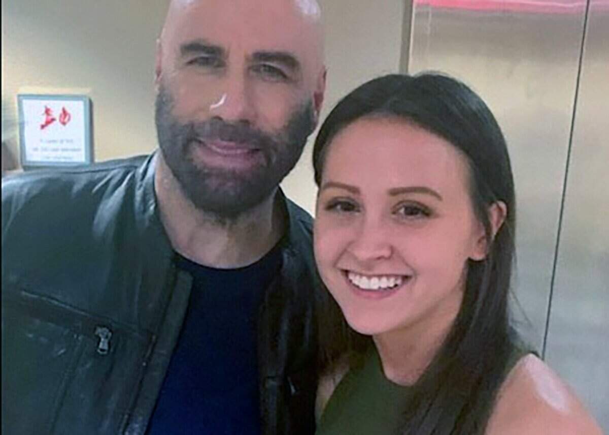 Alex Tyra of Columbus, Georgia, poses with Hollywood star John Travolta inside the Synovus Bank branch in downtown Columbus after he finished acting in his last scene in the movie “Cash Out,” which was filmed June 2022 in Columbus. Cash Out 2 was filmed in South Mississippi and now Cash Out 3 is in production on the Coast.