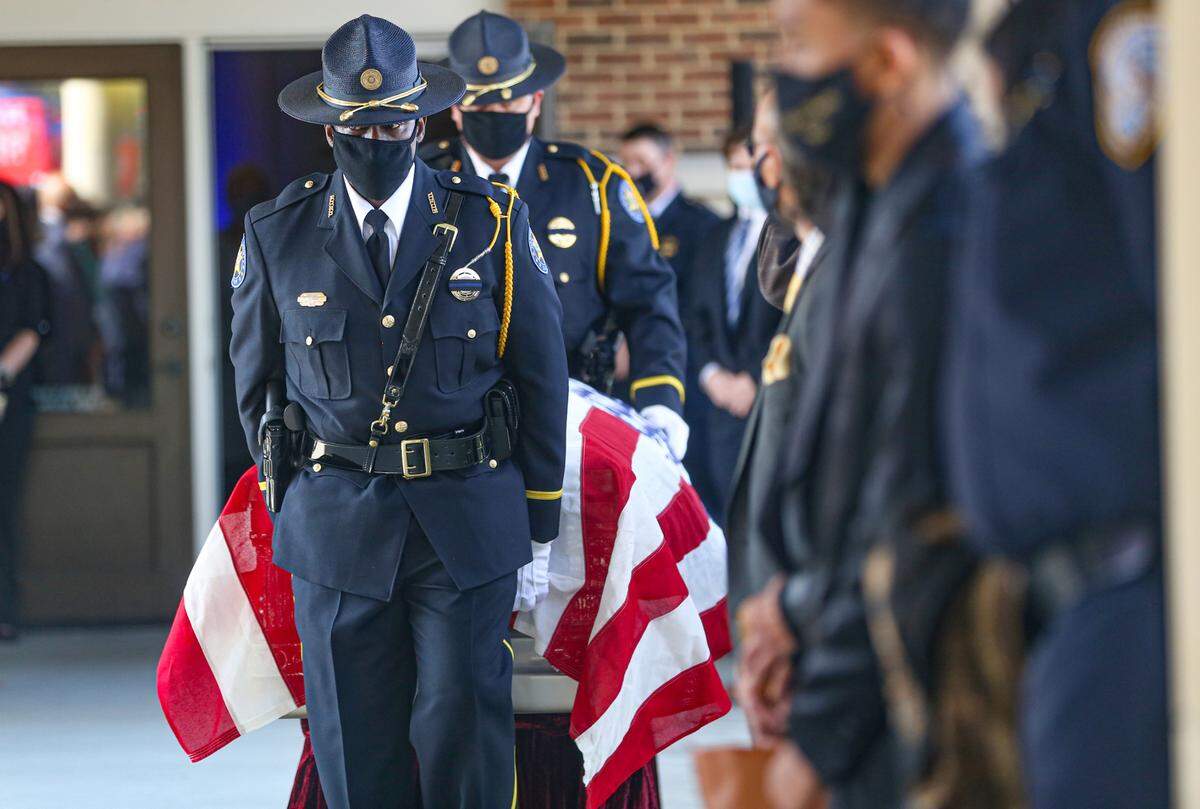 Harrison County Honor Guard escorts the casket of fallen Hancock County Deputy Lt. Michael Boutte outside of the Bay St. Louis Community Hall for law enforcement honors Tuesday, February 9, 2021.