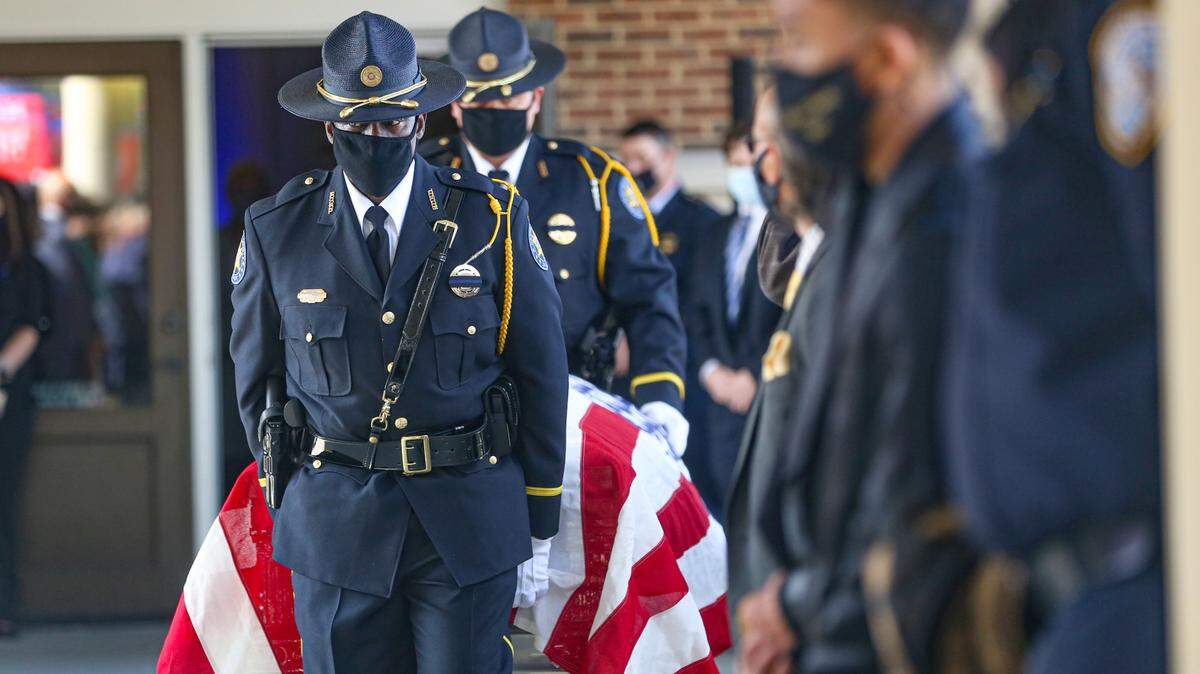 Harrison County Honor Guard escorts the casket of fallen Hancock County Deputy Lt. Michael Boutte outside of the Bay St. Louis Community Hall for law enforcement honors Tuesday, February 9, 2021.