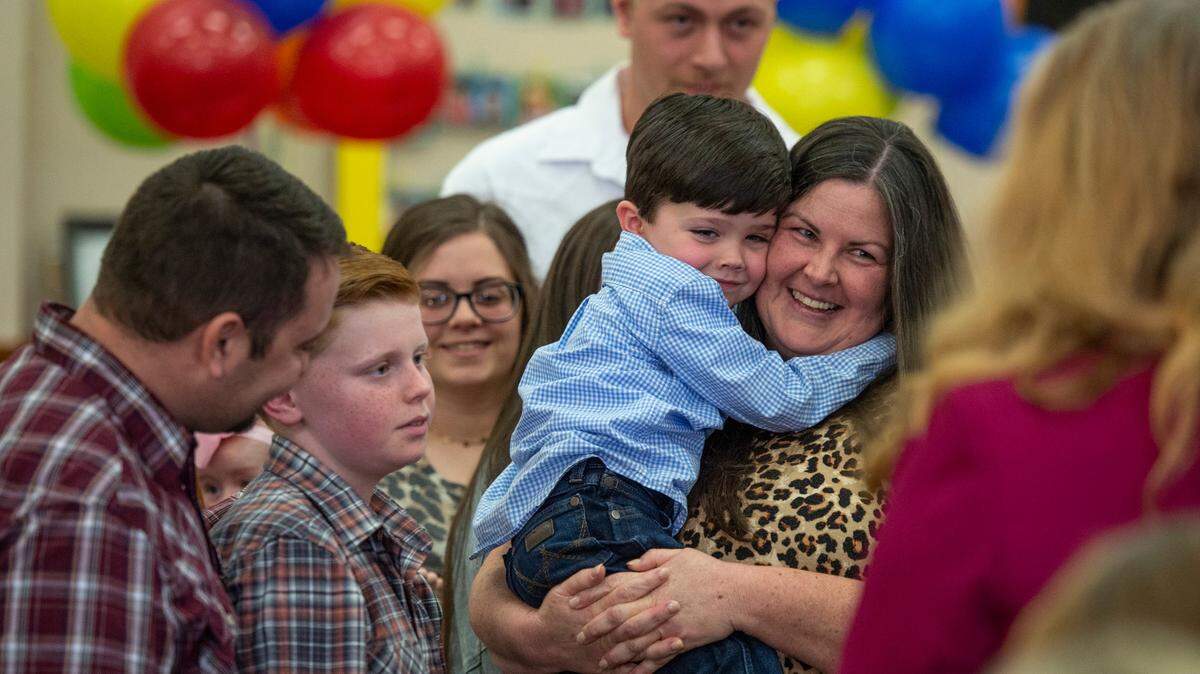 Virginia Byrd, right, holds her newly adopted son Bryson, 5, during an adoption ceremony at the Jackson County Circuit Court in Pascagoula on Thursday, March 10, 2022. The Byrd family also adopted Skylar, 11.