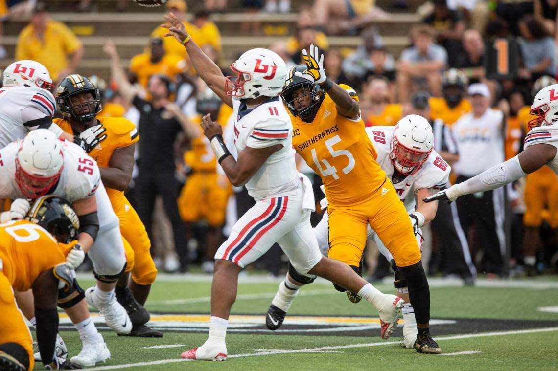 Southern Mississippi linebacker Josh Carr Jr. (45) tries to tackle Liberty’s quarterback during a NCAA college football game in Hattiesburg, Miss., Saturday, Sept. 3, 2022. Southern Mississippi lost 29-27