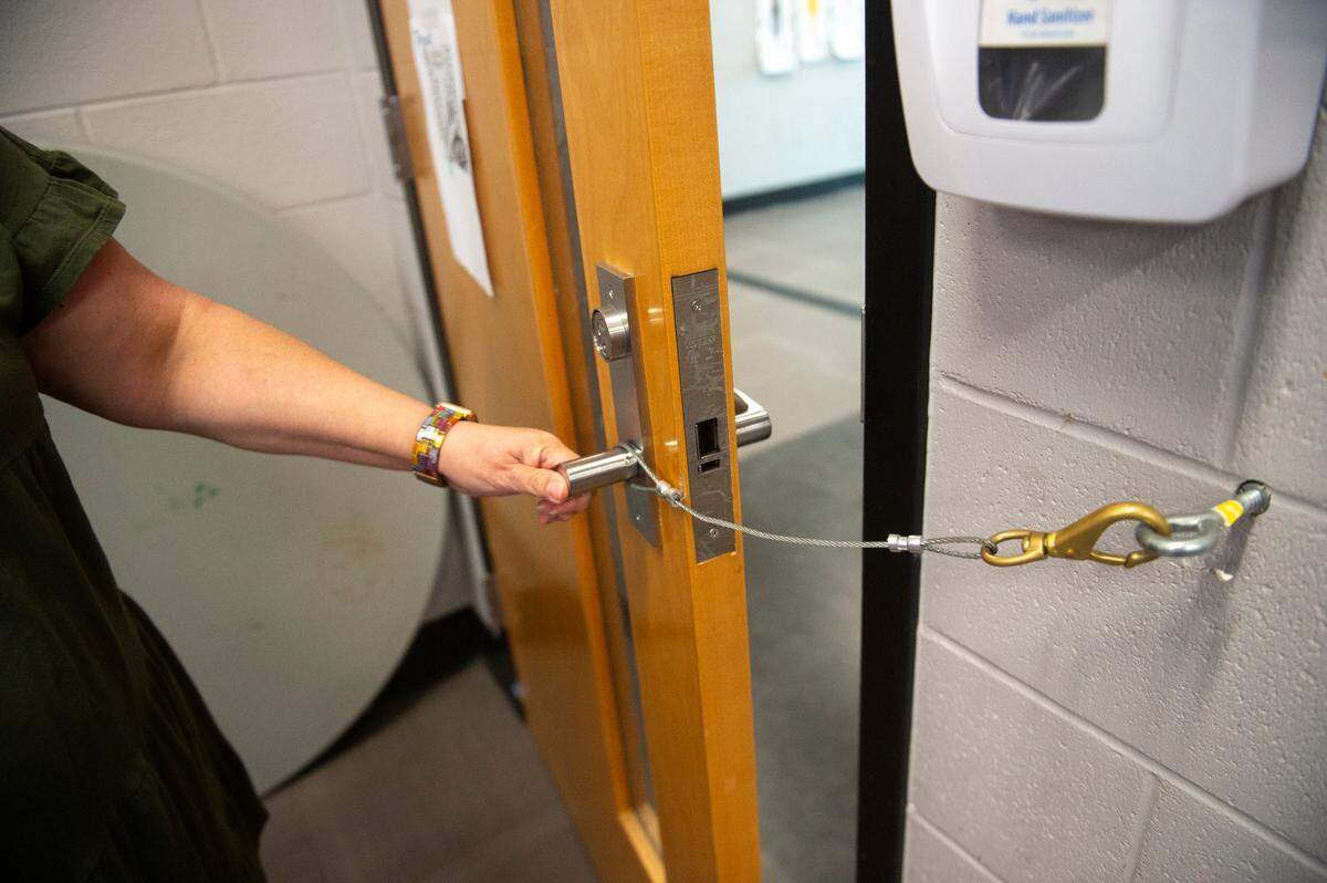 Leigh Anne Meador demonstrates an additional locking system on classroom doors at Long Beach High School on Thursday, Sept. 26, 2024.