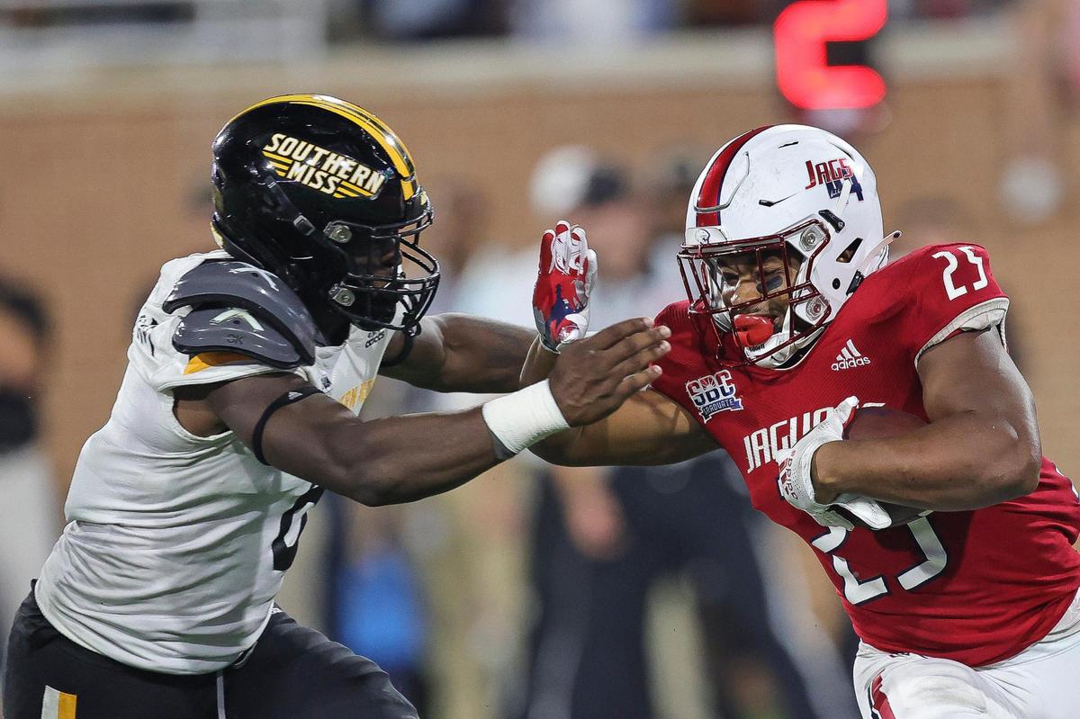 Southern Miss Golden Eagles linebacker Santrell Latham (6) attempts to stop South Alabama Jaguars running back Terrion Avery (25) during the game between Southern Miss and South Alabama at Hancock Whitney Stadium, Mobile, Alabama, September 4, 2021.