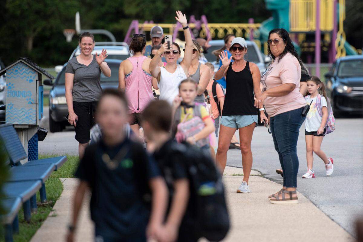 Ocean Springs parents wave goodbye to their kids as they drop them off for the first day of school at Magnolia Park Elementary in Ocean Springs on Friday, Aug. 5, 2022.