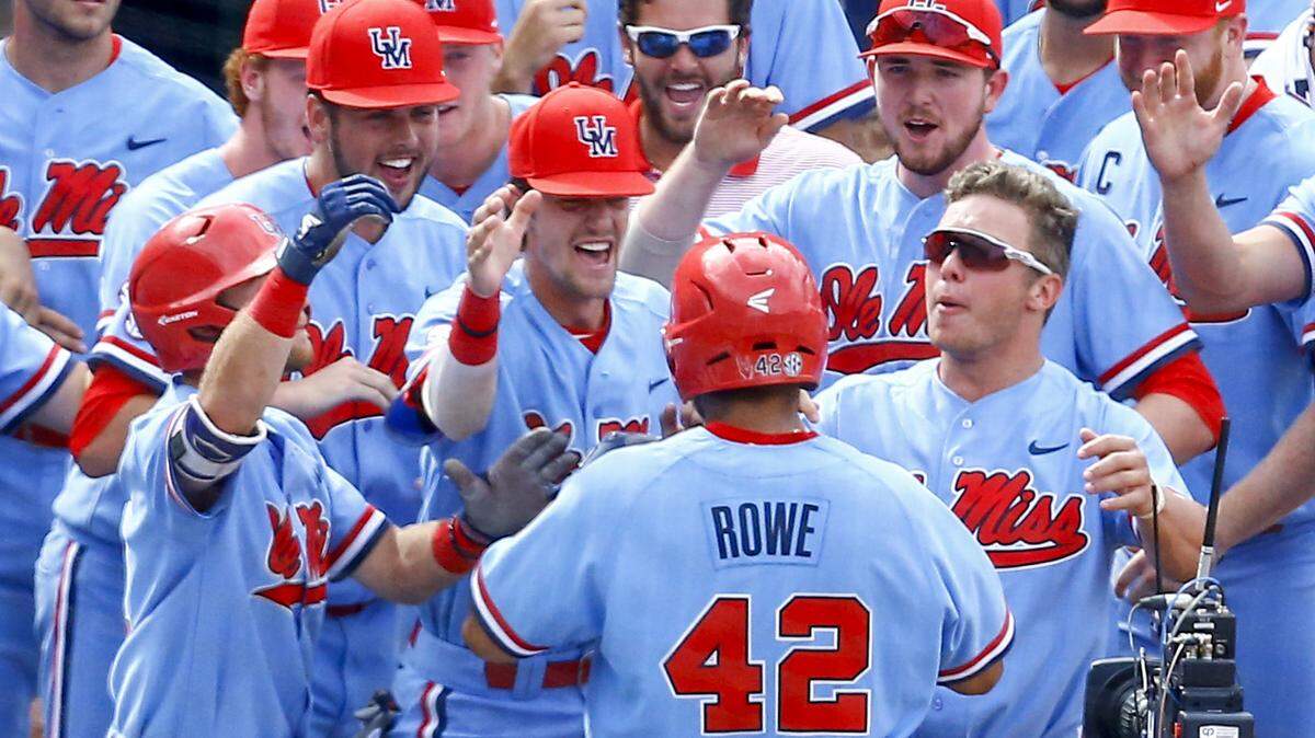 Ole Miss players celebrate after Tim Rowe (42) hit a two-run homer during the seventh inning of the Southeastern Conference tournament game against LSU Sunday in Hoover, Alabama.