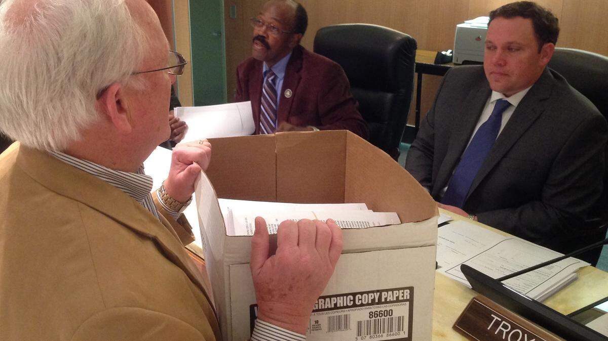 KAREN NELSON/SUN HERALD 
 Attorney Harvey Barton serves Jackson County Supervisors with lawsuits on the Singing River Health Systems retirement fund before their meeting in Pascagoula on Monday March 7, 2015.