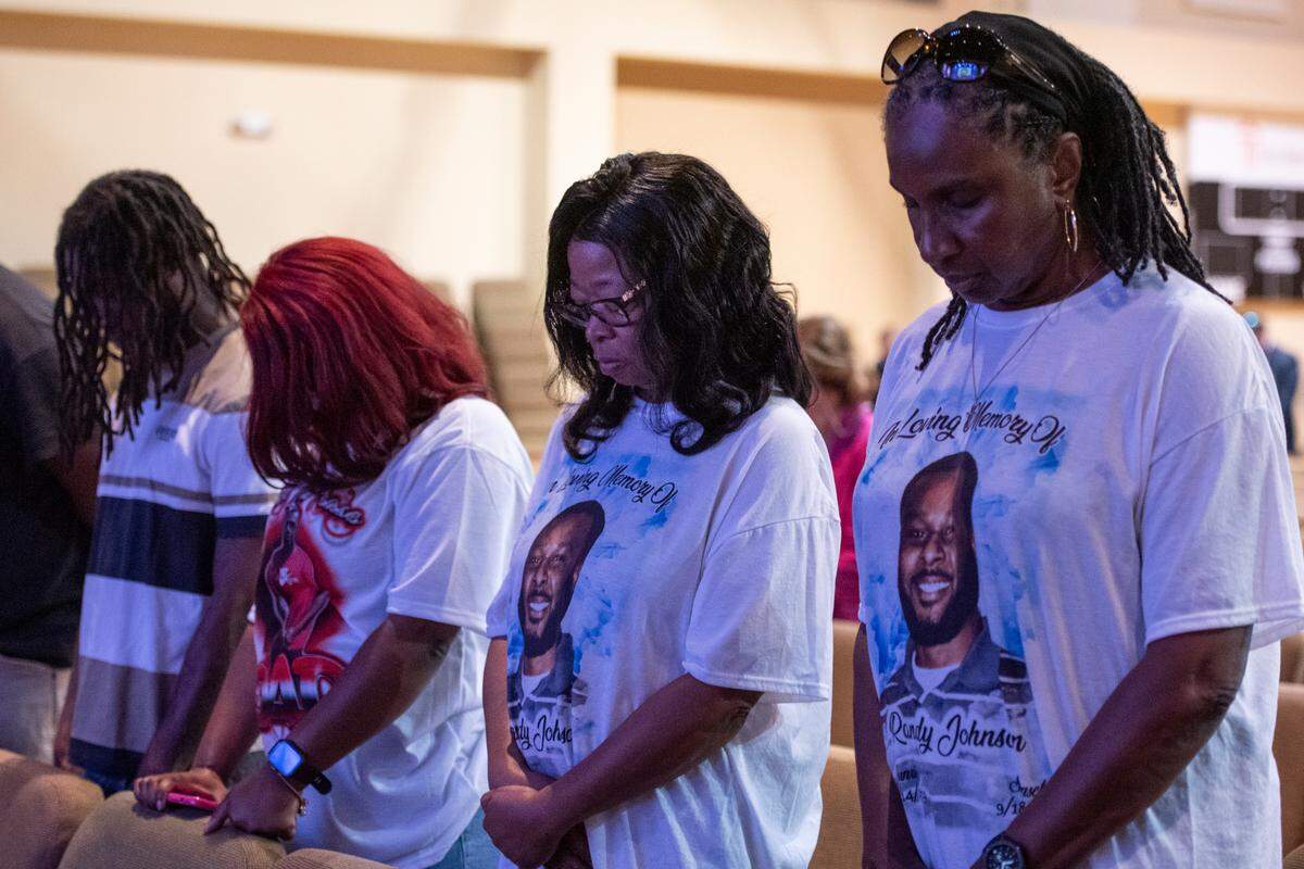 Family members of Randy Johnson pray during a candlelight ceremony as a part of National Crime Victims’ Rights Week at First Baptist Church of Gulfport on Tuesday, April 23, 2024. Randy Johnson, 41, was shot and killed on Sept. 18, 2021 at the Golden Nugget Casino in Biloxi.