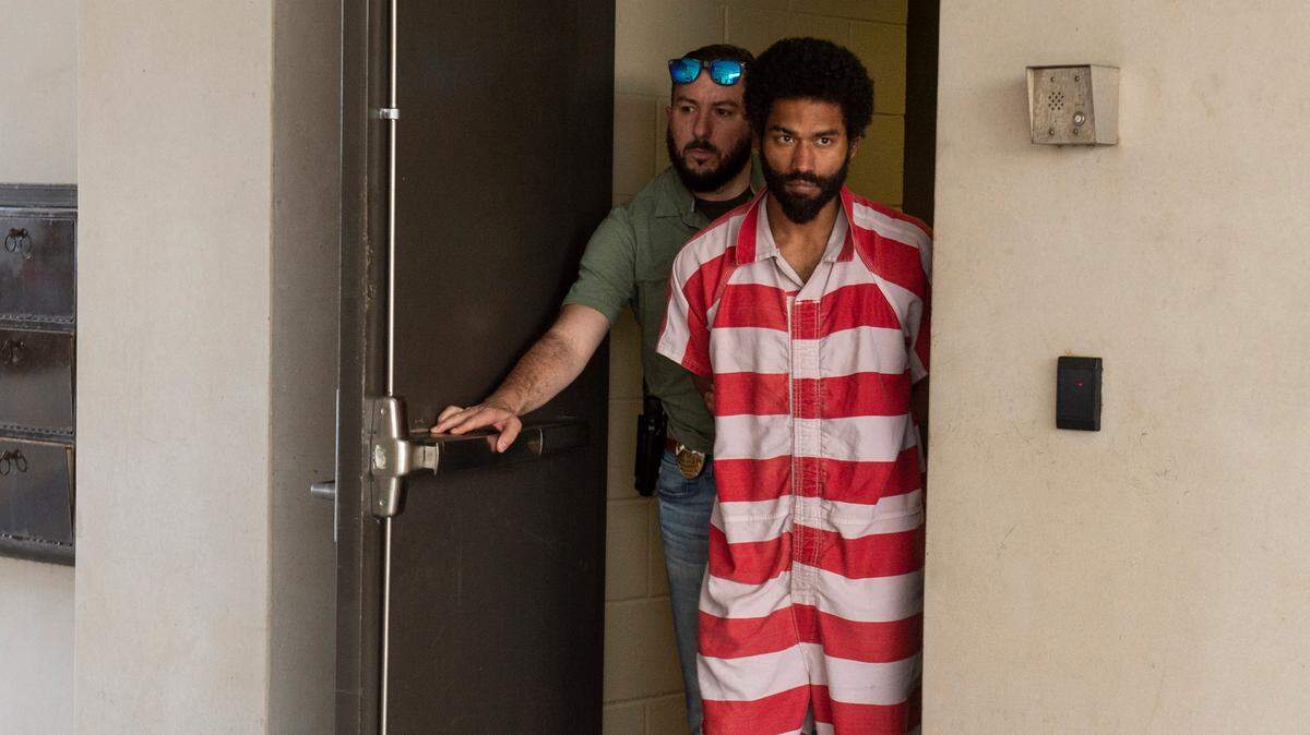 Denilson Marcus Ellison, 27, of Gulfport, is escorted out of the Gulfport Police Department to a waiting vehicle after interviewing with detectives on Friday, April 26, 2024. Ellison is charged with capital murder in the death of his four month old child.