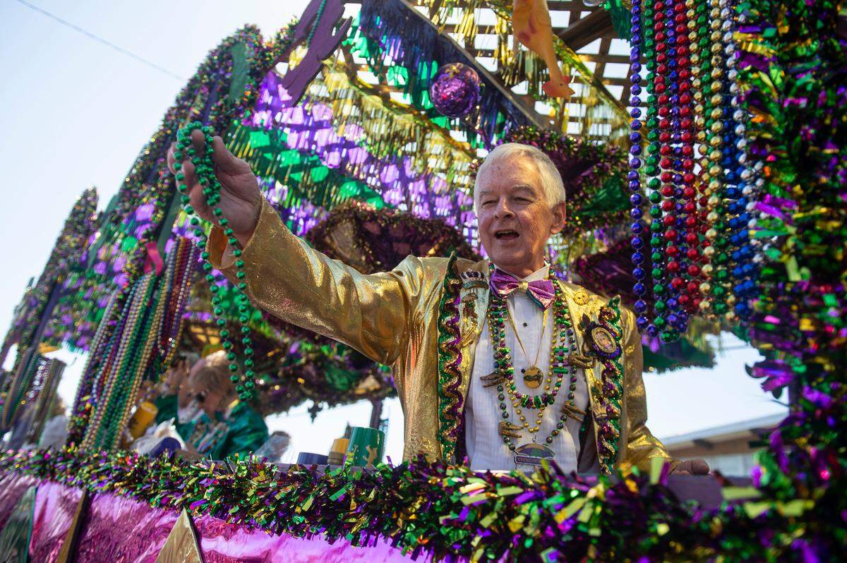 Krewes toss beads and other throws during the Jackson County Carnival Association Mardi Gras parade in Pascagoula on Saturday, March 1, 2025.