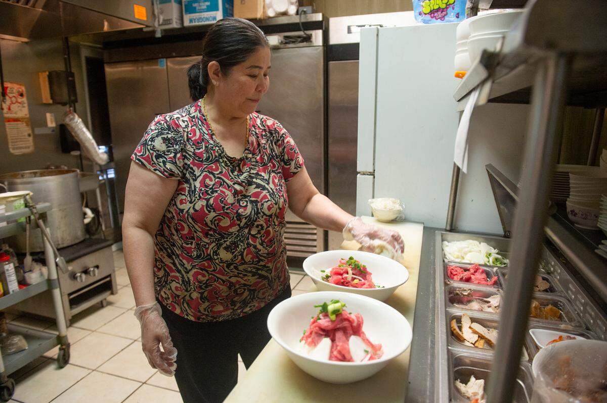 Vung Tau owner Theu Phan prepares bowls of pho at Vung Tau in Biloxi on Thursday, Aug. 3, 2023.