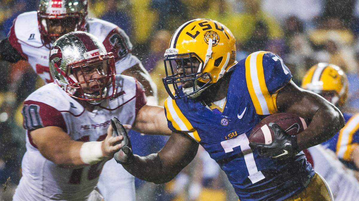 LSU running back Leonard Fournette (7) pushes against Western Kentucky linebacker Nick Holt (10) during an NCAA college football game Saturday, Oct. 24, 2015, in Baton Rouge, La. (Austin Anthony/Daily News via AP) MANDATORY CREDIT