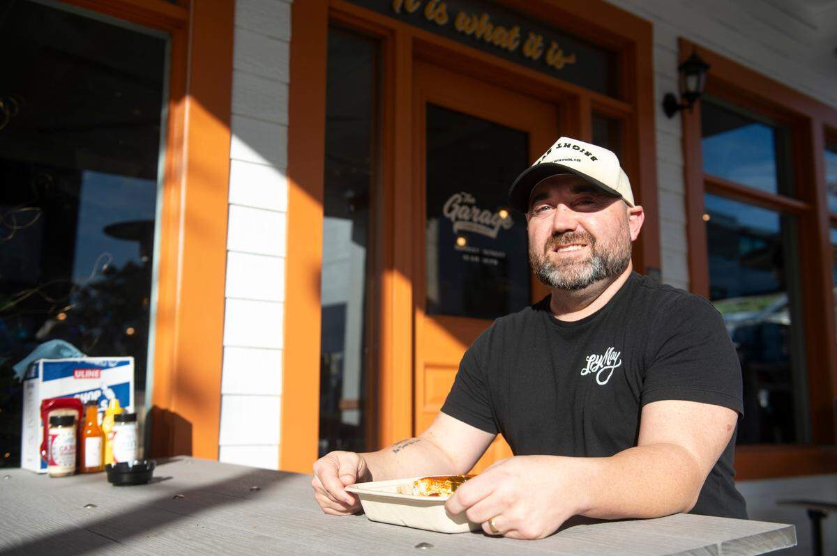 Will Taylor, who owns The Lady May and Glory Bound Gyro Co., poses in front of his latest venture, The Garage at Cash Alley, in Ocean Springs on Friday, Dec. 13, 2024.