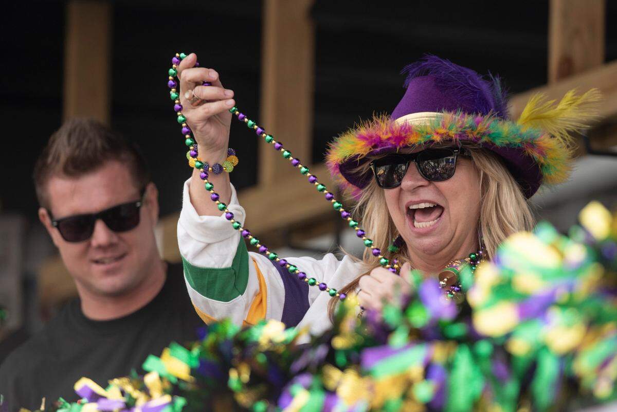 A float rider throws beads to the crowd during the Gulf Coast Carnival Association Mardi Gras parade in Biloxi on Tuesday, March 4, 2025.
