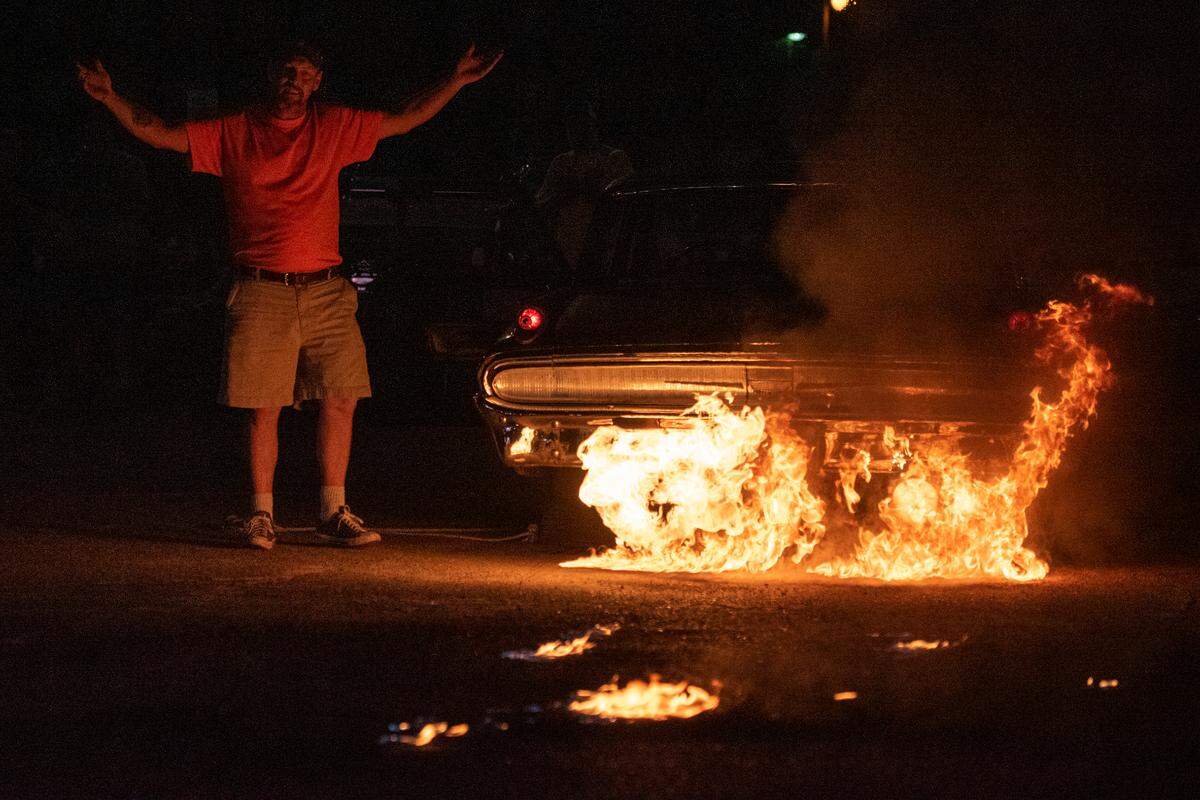 Jason Hamilton reacts as his 1962 Mercury Monterey shoots flames of the tailpipes during a flame throwing competition, where drivers compete to see which car can produce the biggest flames, at Island View Casino in Gulfport during Cruisin’ The Coast 2023.