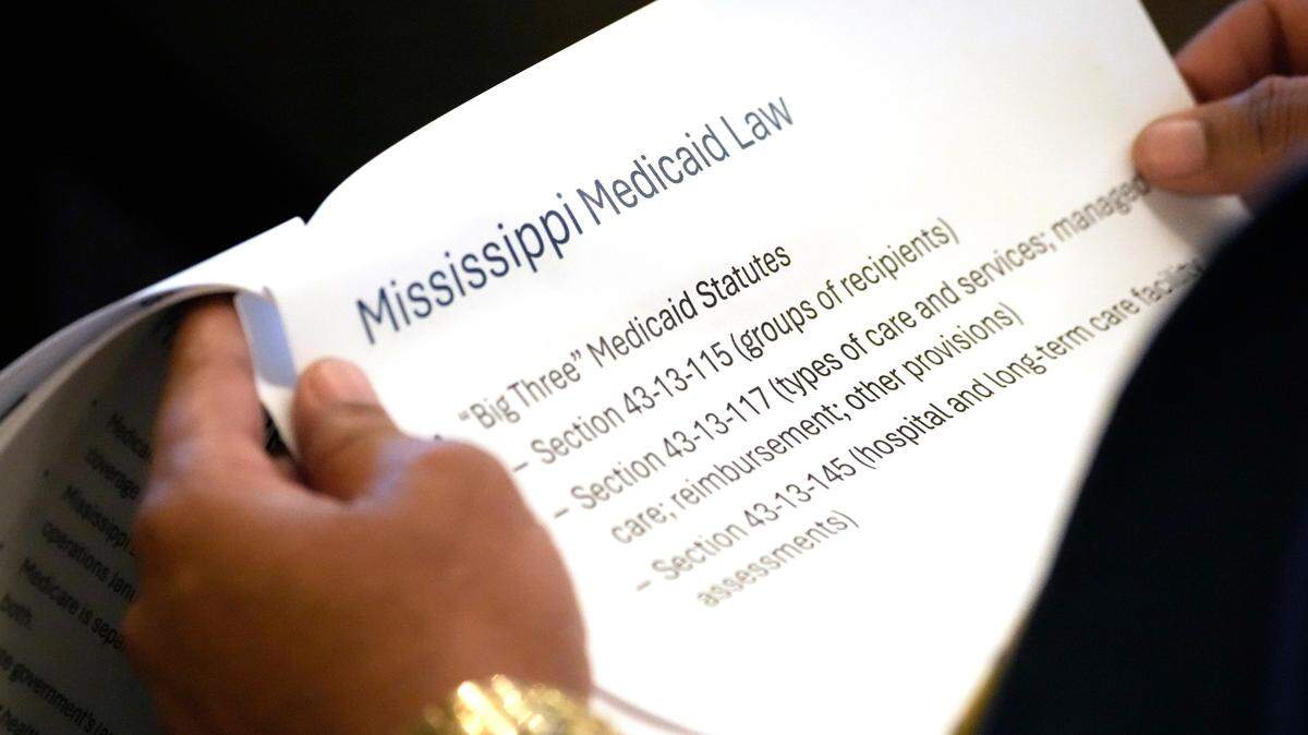 A member of the Mississippi House of Representatives studies an panel of the outline on Mississippi Medicaid provided Wednesday to the House Medicaid Committee at the Mississippi Capitol.
