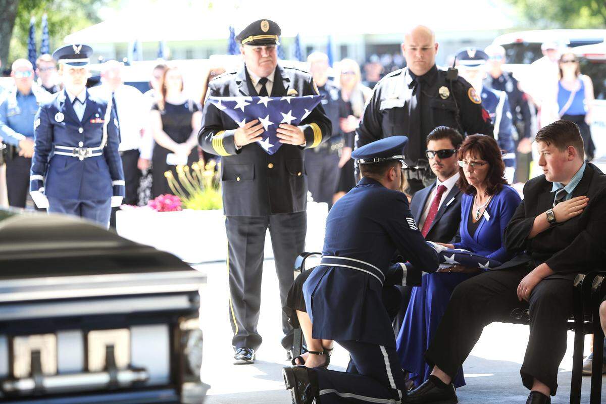 A U.S. Air Force Guard member hands the folded flag once atop the casket of slain Biloxi patrol officer Robert “Mac” McKeithen to his wife, Pamela McKeithen, during the officer’s funeral on Monday, May 13, 2019, at the Biloxi National Cemetery.